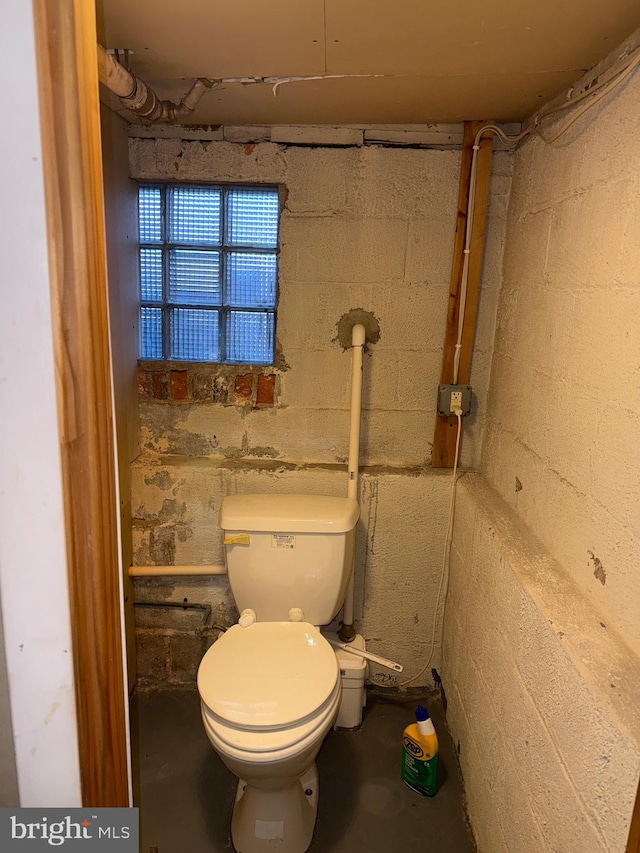 bathroom with toilet and concrete floors