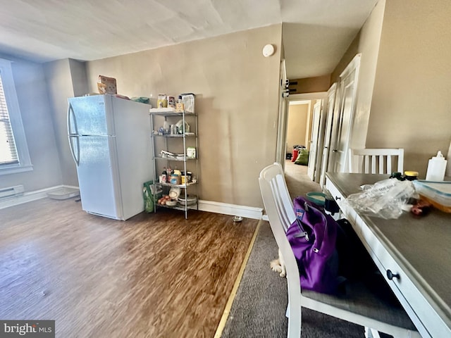 home office with hardwood / wood-style flooring and baseboard heating