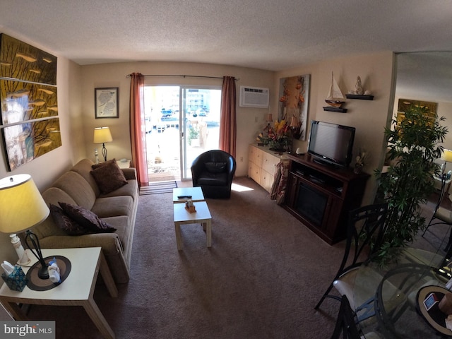 carpeted living room with an AC wall unit and a textured ceiling