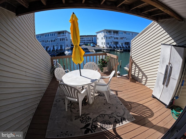 wooden deck featuring a water view