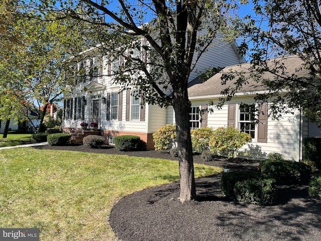 view of property exterior featuring a lawn