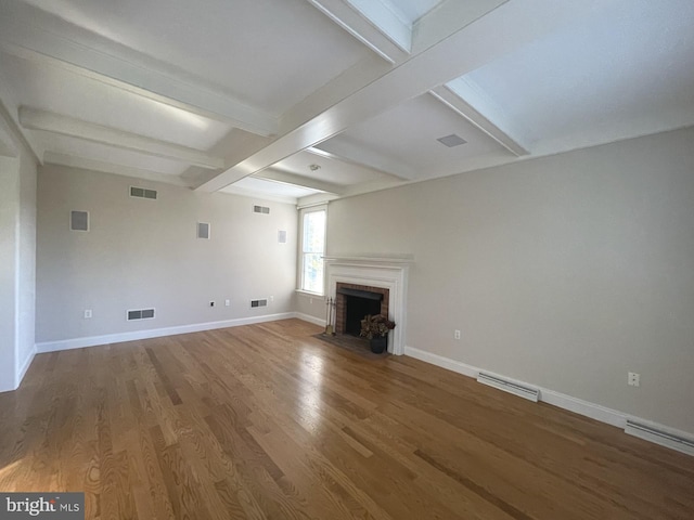 unfurnished living room with a fireplace, beam ceiling, and hardwood / wood-style floors