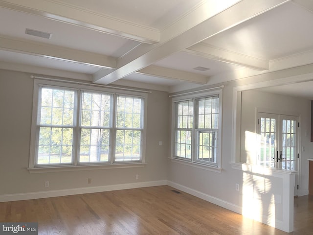 spare room featuring wood-type flooring, french doors, and beamed ceiling