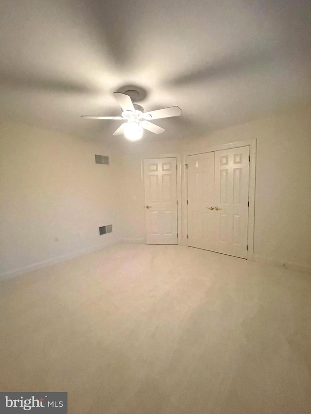 unfurnished bedroom with ceiling fan and carpet