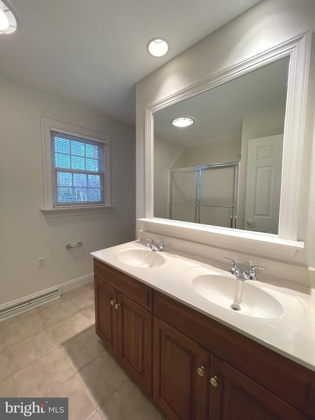 bathroom with an enclosed shower, tile patterned floors, and vanity