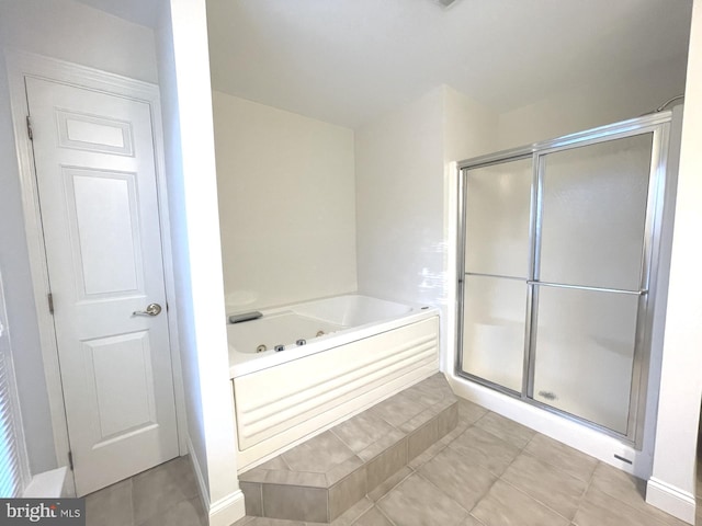 bathroom featuring tile patterned floors and separate shower and tub