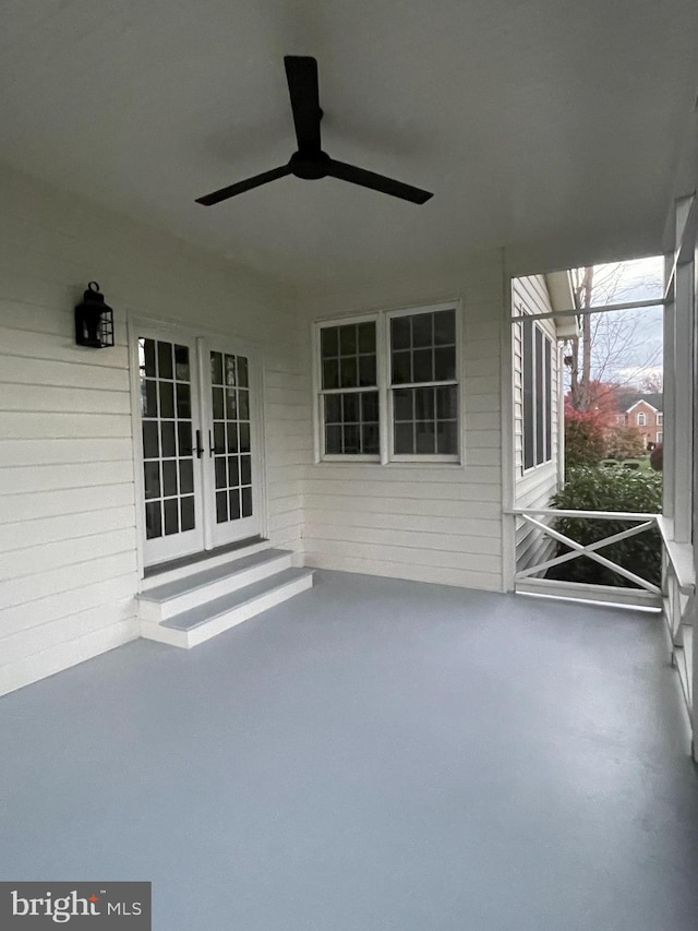 unfurnished sunroom with ceiling fan