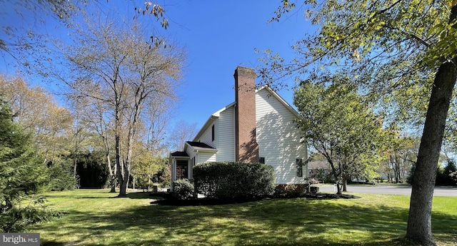 view of side of home featuring a lawn