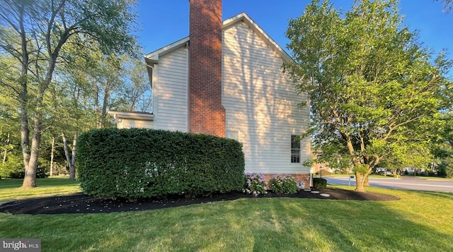 view of home's exterior with a yard