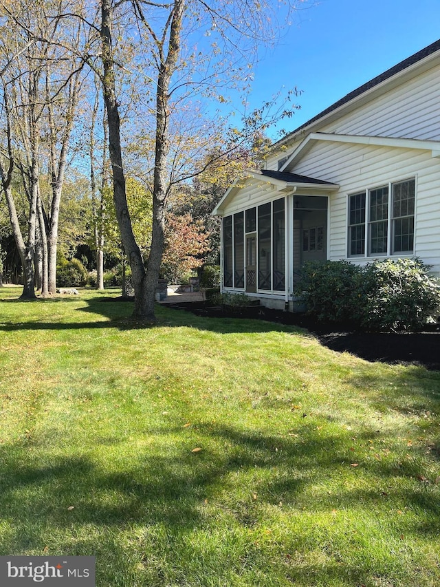 view of yard with a sunroom