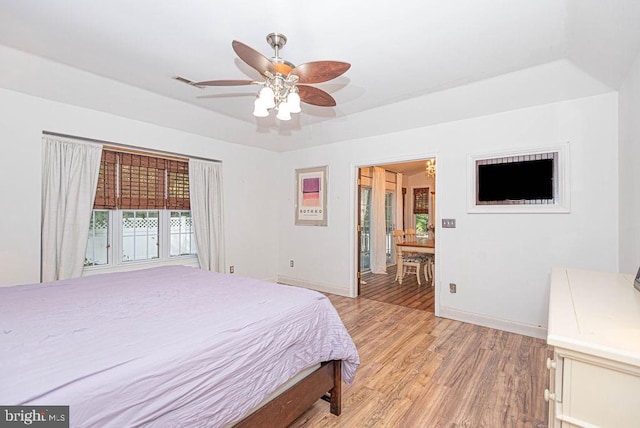 bedroom with ceiling fan and hardwood / wood-style flooring