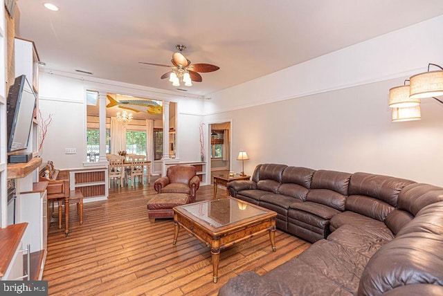 living room with ceiling fan, decorative columns, and light hardwood / wood-style flooring