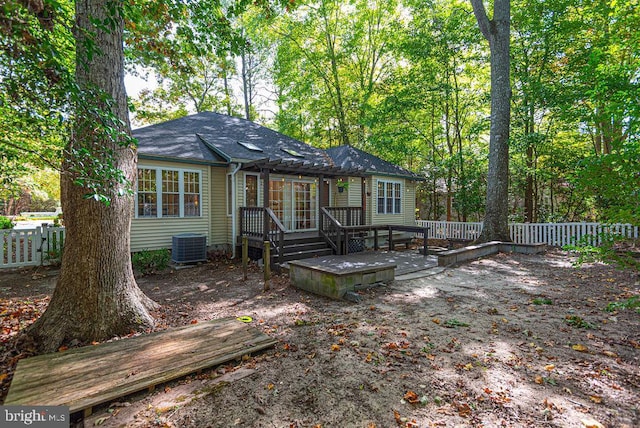 rear view of property featuring central AC and a deck