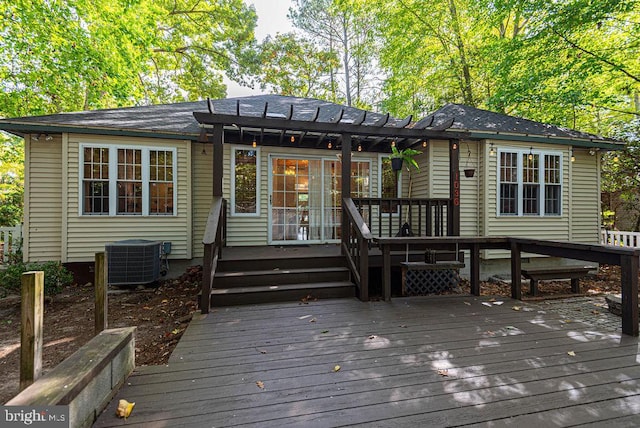 back of property featuring a pergola, a deck, and central AC unit