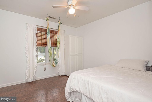 bedroom with dark wood-type flooring and ceiling fan