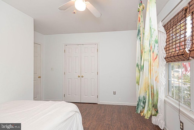 bedroom with dark hardwood / wood-style floors, a closet, and ceiling fan