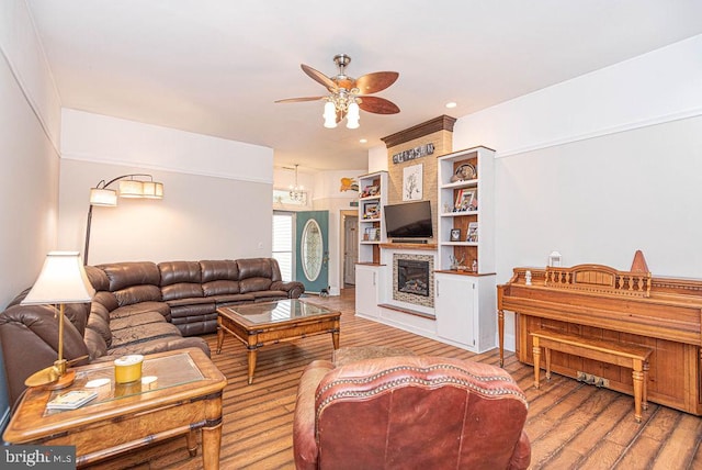 living room with wood-type flooring and ceiling fan