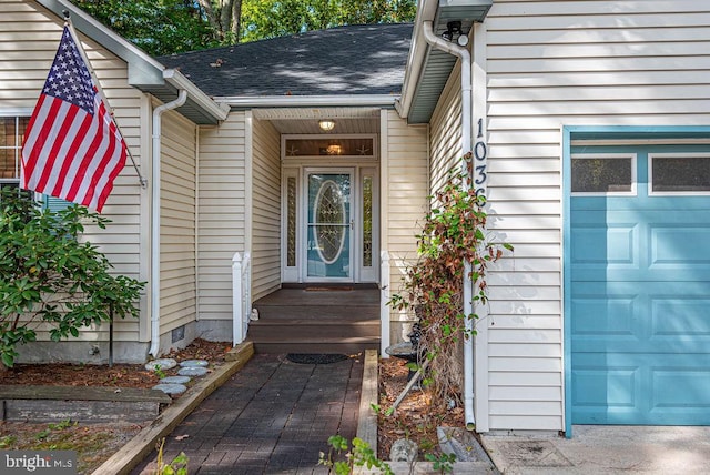 doorway to property with a garage