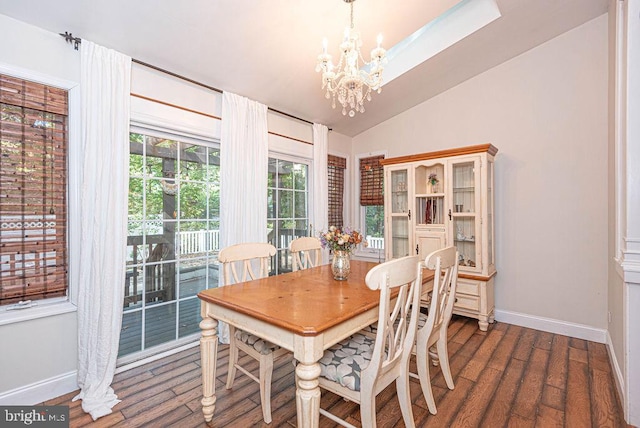 dining room with a notable chandelier and vaulted ceiling