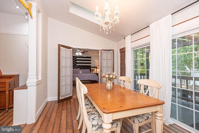 dining space featuring dark wood-type flooring, ceiling fan with notable chandelier, and vaulted ceiling