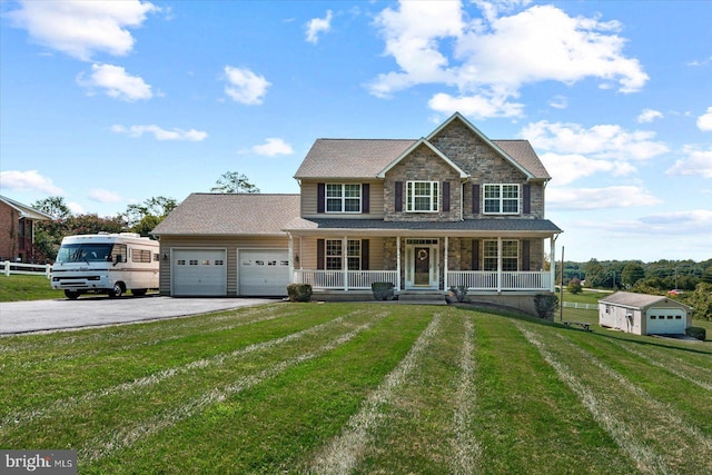 view of front of house with covered porch, a front lawn, and a garage