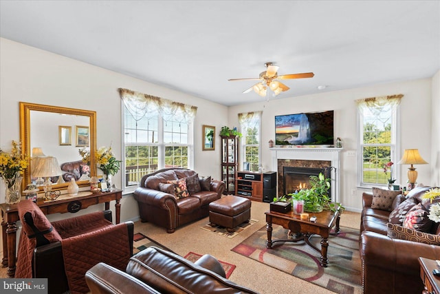 living room with a fireplace, carpet floors, and ceiling fan