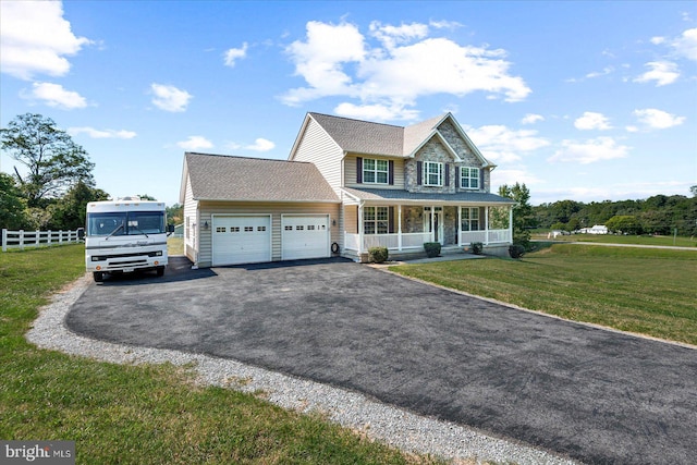 view of front facade featuring a garage, a front lawn, and a porch