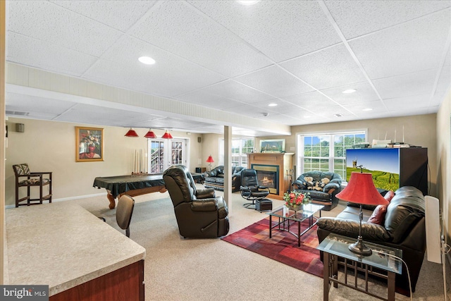 living room featuring a drop ceiling, carpet flooring, and billiards