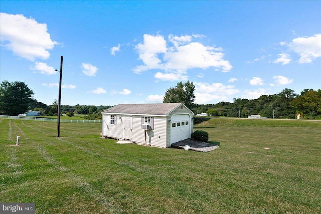 view of outdoor structure with a rural view, a yard, and cooling unit