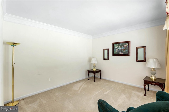 sitting room featuring ornamental molding and light colored carpet