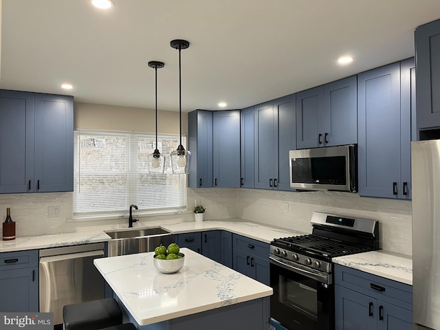 kitchen featuring sink, a kitchen island, backsplash, pendant lighting, and appliances with stainless steel finishes