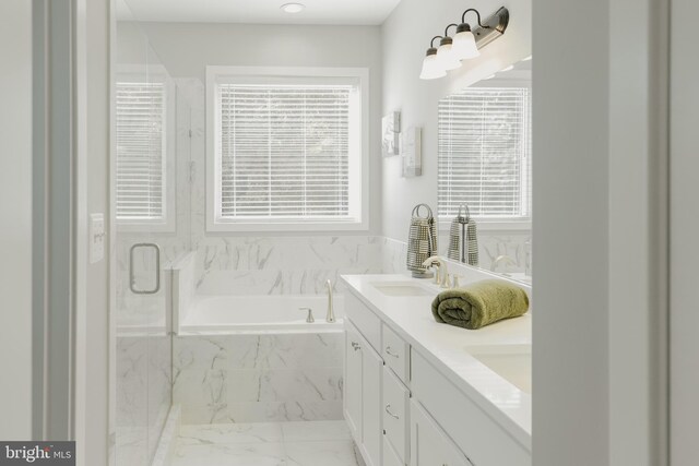 bathroom featuring vanity and independent shower and bath