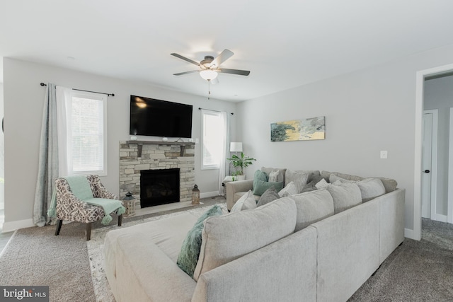 living room with light carpet, a fireplace, and ceiling fan