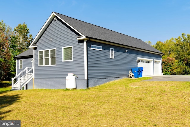 view of home's exterior featuring a lawn and a garage