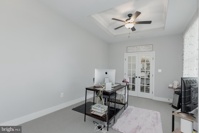 carpeted office featuring ceiling fan, a tray ceiling, french doors, and ornamental molding