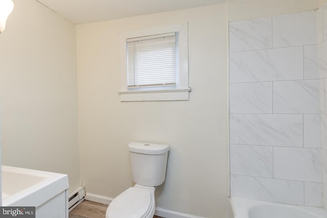 bathroom with baseboard heating, hardwood / wood-style floors, vanity, and toilet