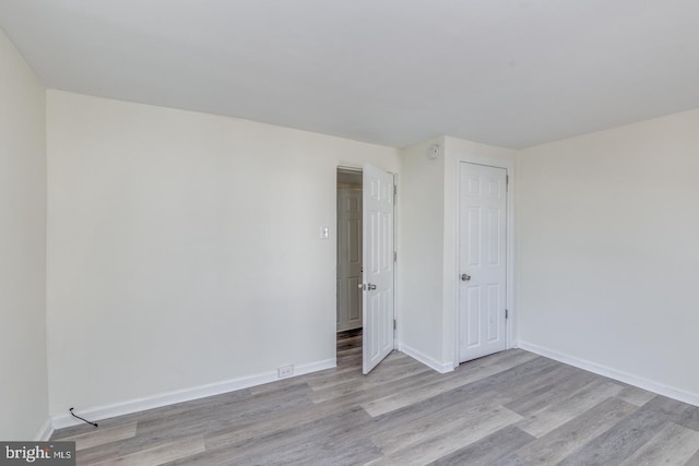 spare room with light wood-type flooring