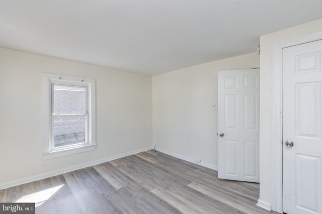 spare room with light hardwood / wood-style flooring