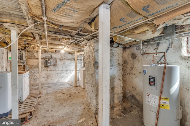 basement with electric water heater, gas water heater, and washer / dryer