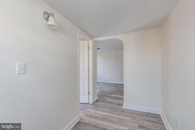 hallway with light hardwood / wood-style floors