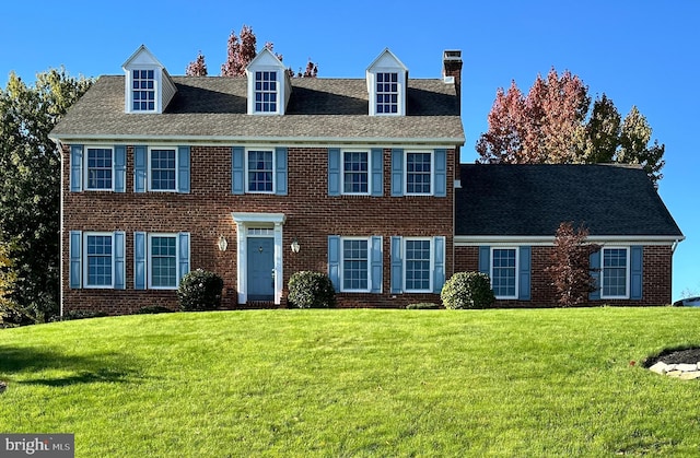 colonial inspired home with a front yard