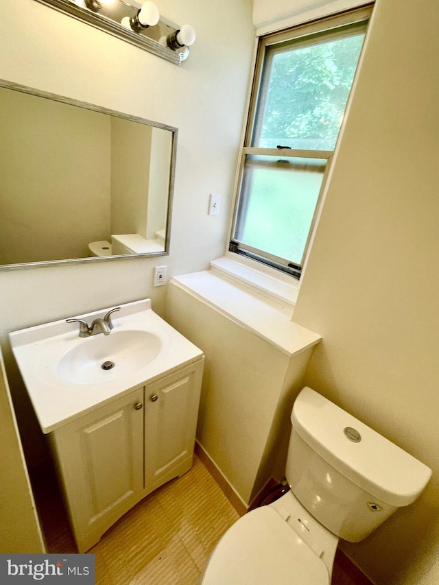 bathroom featuring vanity, toilet, and tile patterned flooring