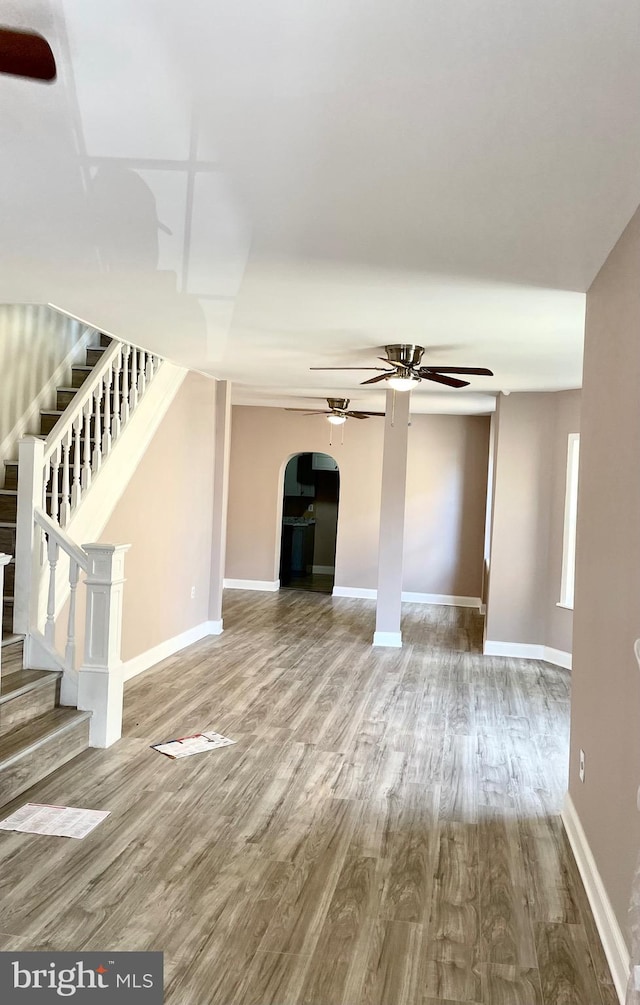 unfurnished living room with ceiling fan and hardwood / wood-style flooring