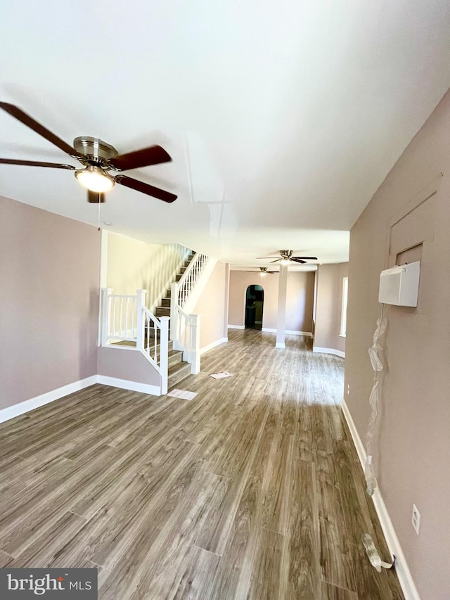 unfurnished living room with hardwood / wood-style floors and ceiling fan