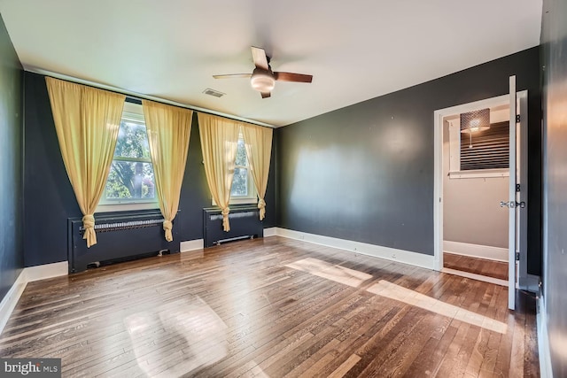 empty room featuring hardwood / wood-style floors and ceiling fan