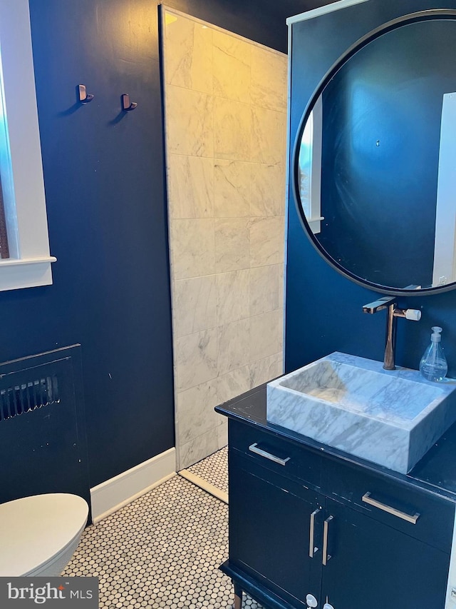 bathroom with vanity, toilet, and tile patterned flooring