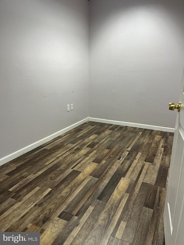 spare room with dark wood-type flooring