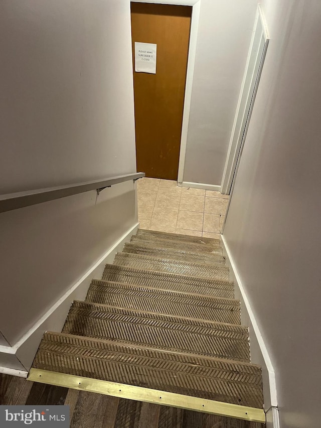 staircase with tile patterned flooring