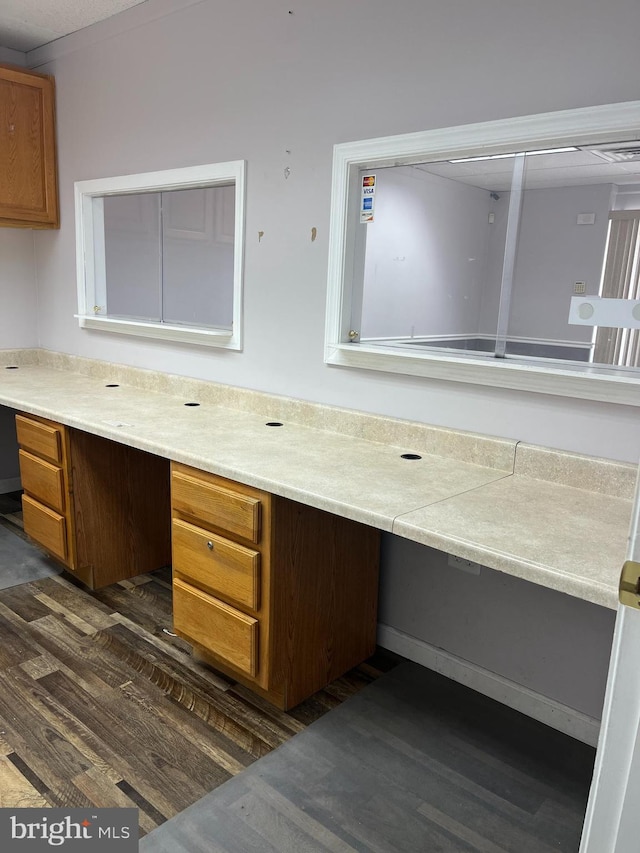 interior space with built in desk and dark hardwood / wood-style flooring