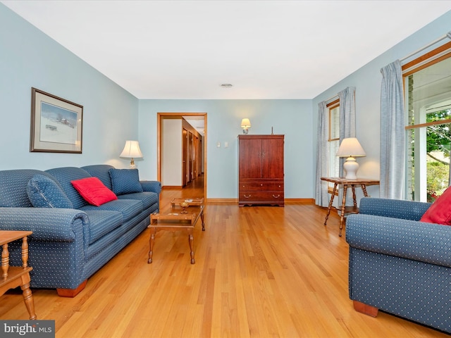 living room featuring baseboards and wood finished floors